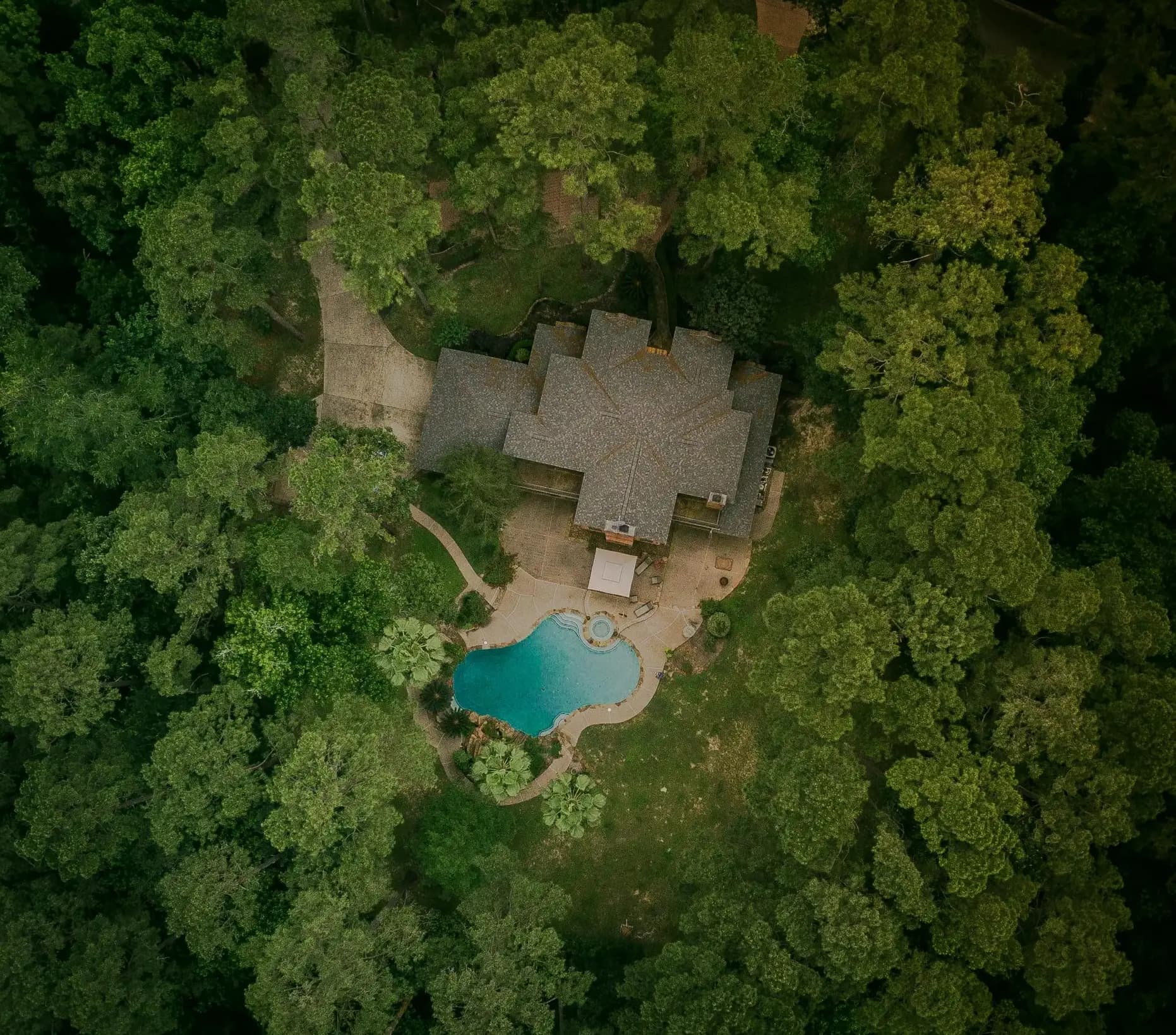 Aerial view of an Atlanta luxury estate surrounded by mature hardwood trees