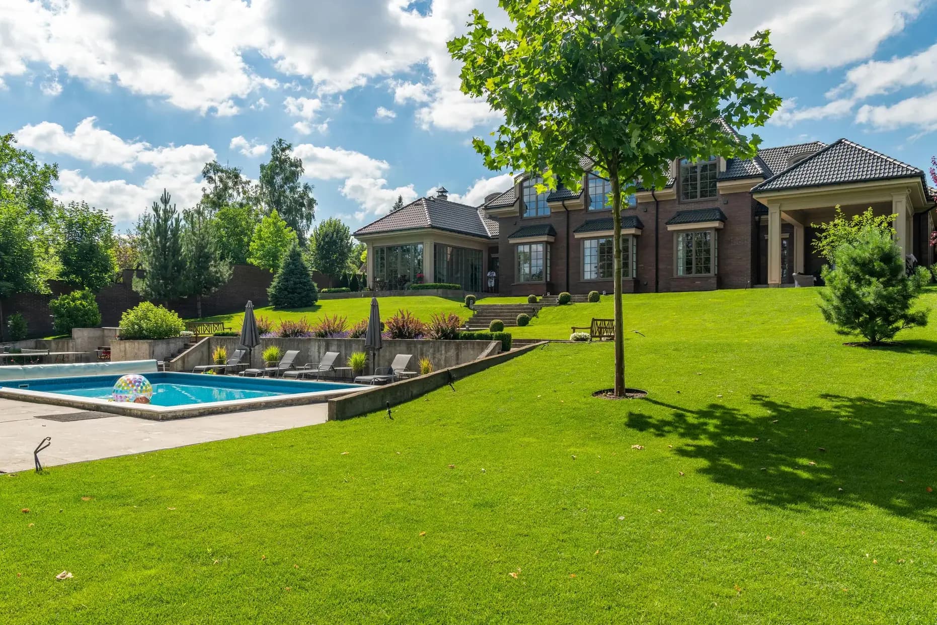 Resort-style pool and outdoor living at a Tuxedo Park estate