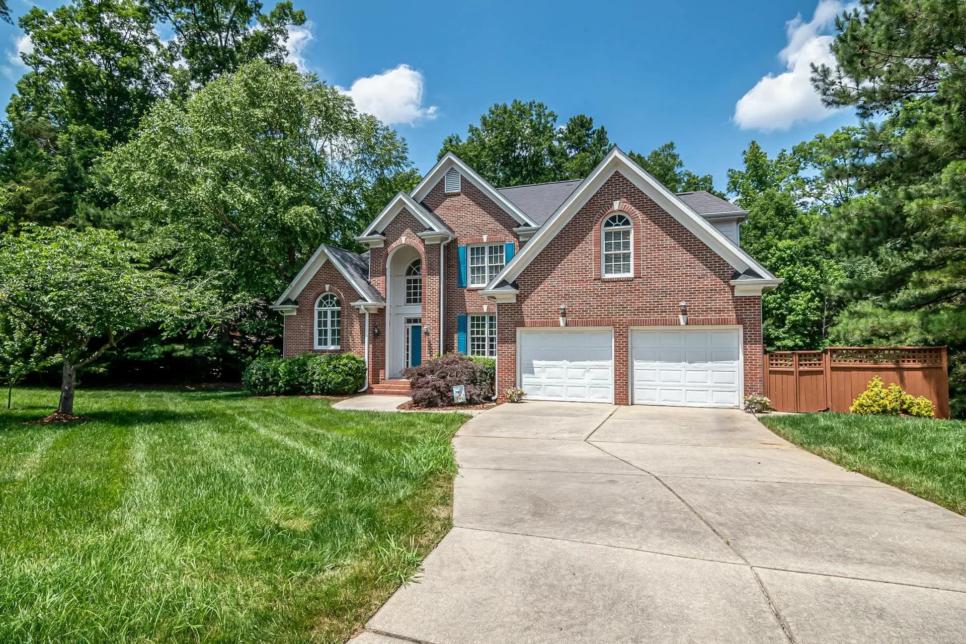 Luxury Buckhead Atlanta home exterior with brick facade and mature trees