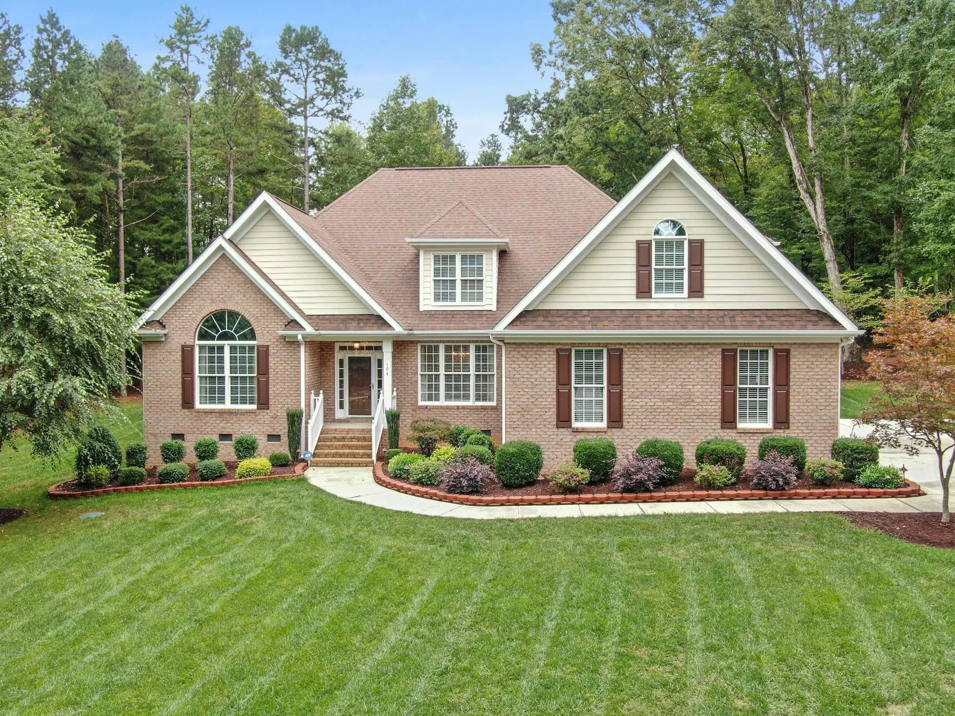A luxury neighborhood street in Brookhaven, Atlanta with new construction homes and mature trees