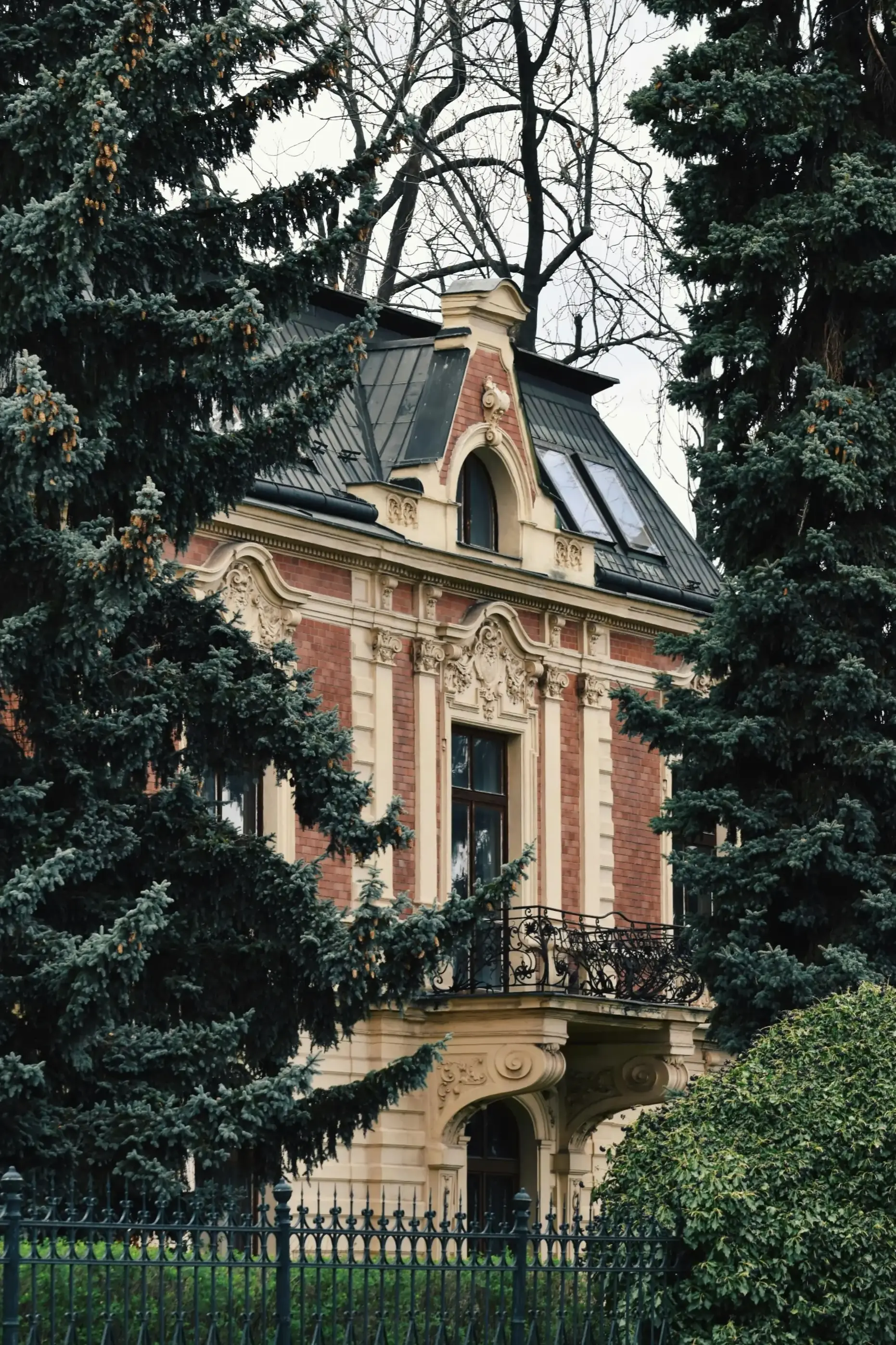 European-style luxury villa exterior with French architectural details and mansard roof