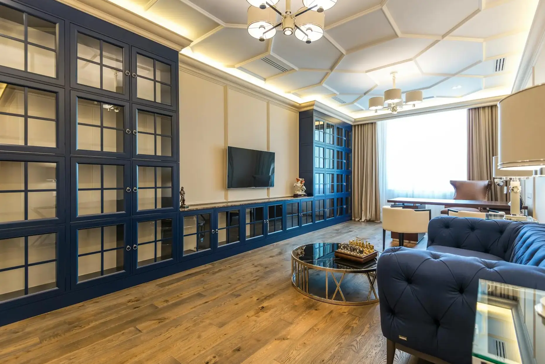 Library and living room with navy accents inside a renovated North Highland craftsman