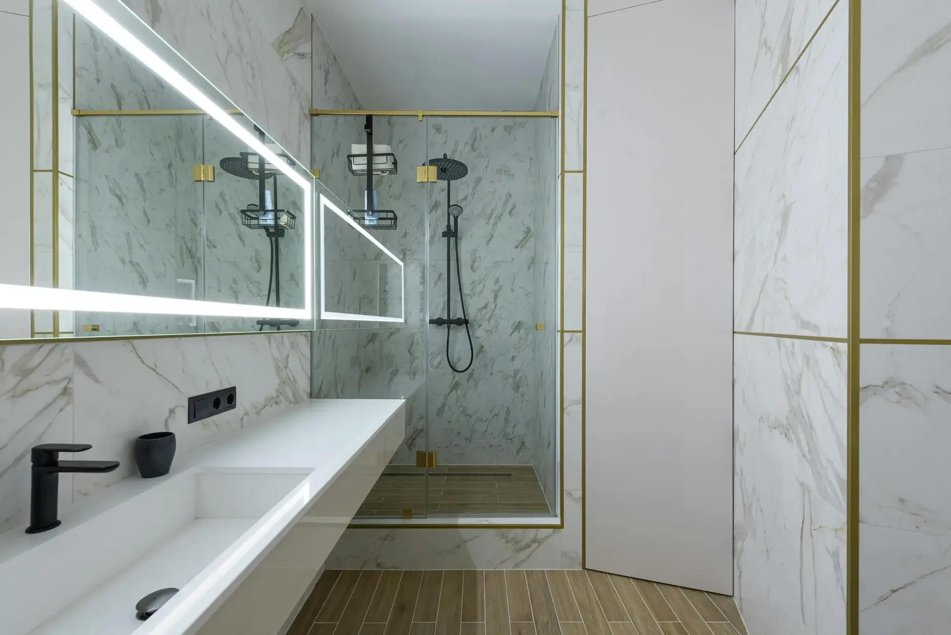 Spa Bathroom with Marble and Gold Luxury spa bathroom with calacatta marble walls, gold trim and glass rain shower