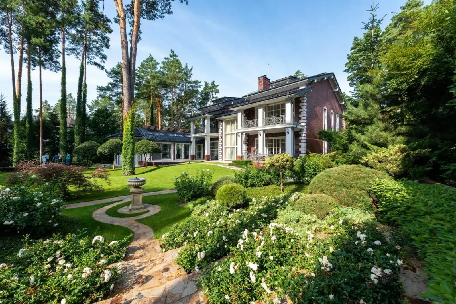 Luxury Atlanta home with manicured spring landscaping and blooming azaleas - curb appeal preparation for listing