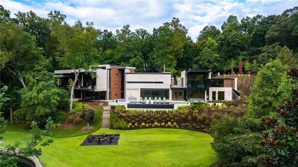 Green Pine Drive Atlanta modern luxury home aerial view with glass walls and wooded setting