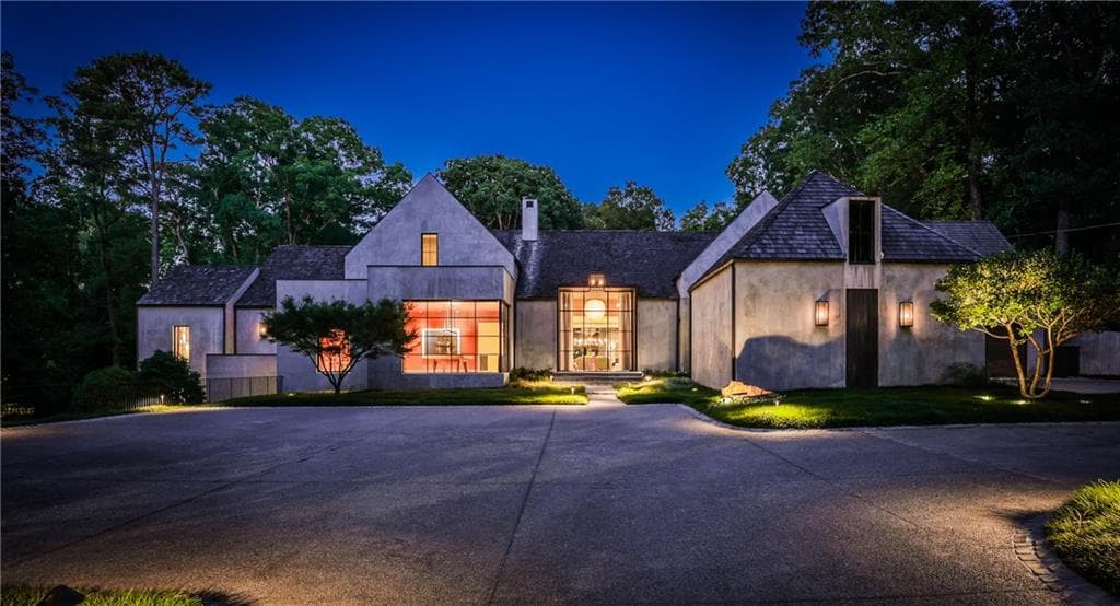 Tuxedo Road Atlanta contemporary mansion exterior at twilight with illuminated windows